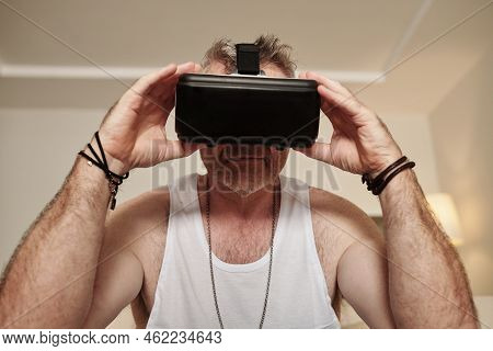 Portrait Of Mature Man Teasting Virtual Reality Goggles