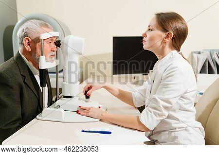 Ophthalmologist Examination Of Elderly Man On Corneo Topographer.modern Clinic