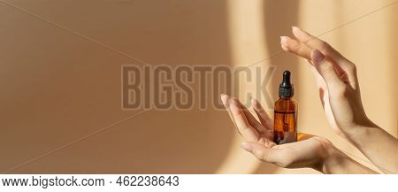 Concept Of Mockup. Glass Bottle With Dropper Lid With Collagen Moisturizing Hyaluronic Serum In Morn