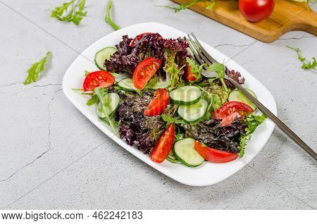 Healthy Vegetable Salad With Fresh Salad Leaves, Arugula, Cherry Tomato, Cucomber And Parsley In Pla