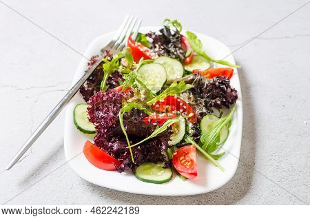 Healthy Vegetable Salad With Fresh Salad Leaves, Arugula, Cherry Tomato, Cucomber And Parsley In Pla