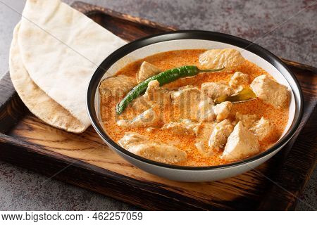 Spicy Kukul Mas Chicken Breast Curry With Coconut Milk And Spices Close-up In A Bowl On A Wooden Tra
