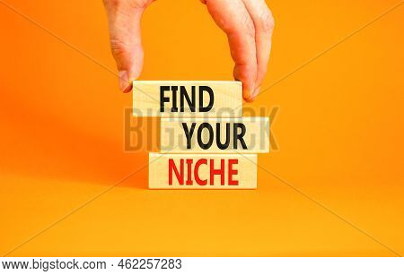 Find Your Niche Symbol. Concept Words Find Your Niche On Wooden Blocks. Businessman Hand. Beautiful 