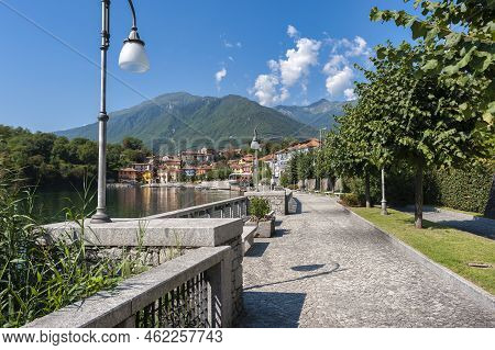 Promenade On The Lago Di Mergozzo With A View Of The Village Of Mergozzo. Mergozzo Is A Village In T