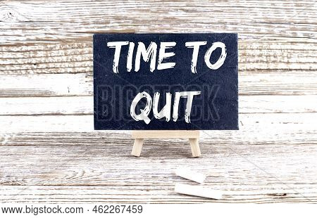 Time To Quit Text On Miniature Chalkboard On Wooden Background