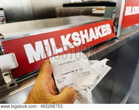 Paris, France - Sep 21, 2022: Five Guys American Fast Food Restaurant With Customer Holding Receipt 