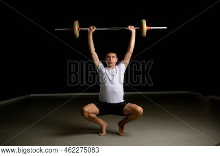 19 Year Old Teenage Boy Lifting A Barbell Above His Head
