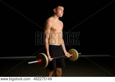 Shirtless 19 Year Old Teenage Boy Excercsing His Bicpes With A Barbell