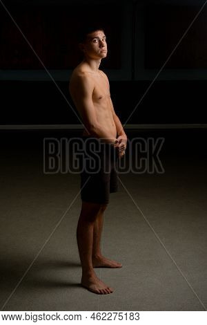 A Shirtless 19 Year Old Teenage Boy With A Black Background