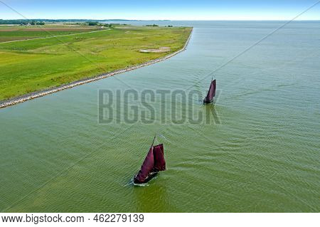 Aerial From Traditional Dutch Wooden Boats At The Ijsselmeer Near The Harbor From Laaxum In Frieslan