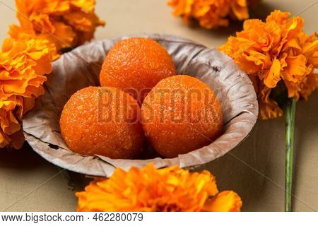 Close up of Bundi or Motichoor Laddu served in a leaf bowl as Prasad or Bhog for deities. Indian authentic sweets and desserts.