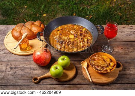 Festive Table For Rosh Hashanah Cholent With Chicken, Pomegranate, Wine, Honey, Apples, Challah. Hor