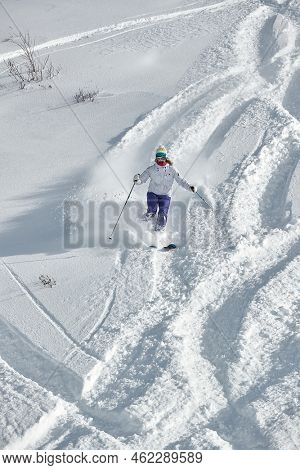 VALMOREL, FRANCE -CIRCA 2019: Skier coming down fast in fresh powder snow off-piste free ride. Plowing snow