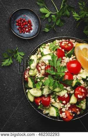 Bulgur Tabbouleh Salad With Fresh Tomatoes, Cucumbers, Parsley And Lemon Dressing. Traditional Middl