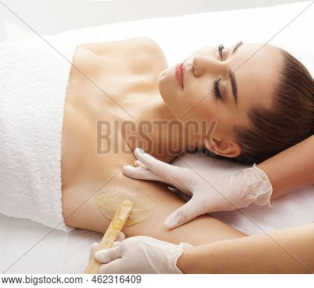 Hair Removal, Beauty And Health Concept. A Young Girl Is Getting An Epilation Procedure. A Processio