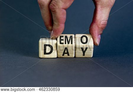 Demo Day Symbol. Concept Words Demo Day On Wooden Cubes. Businessman Hand. Beautiful Grey Table Grey