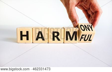 From Harmful To Harmony. Businessman Turns The Wooden Cube And Changes Word Harmful To Harmony. Beau