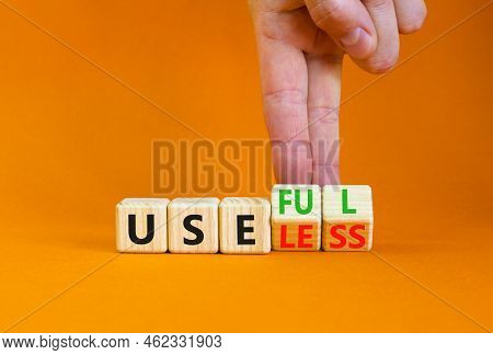 Useful Or Useless Symbol. Concept Words Useful Or Useless On Wooden Cubes. Businessman Hand. Beautif