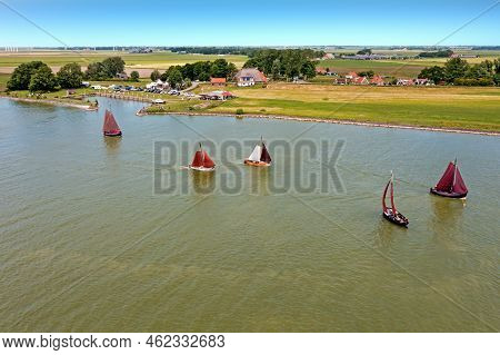 Aerial From Traditional Dutch Wooden Boats At The Ijsselmeer Near The Harbor From Laaxum In Frieslan
