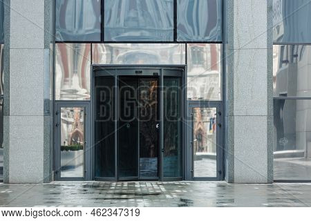 Revolving Glass Door Of Modern Office Business Center. Entrance Of The Commercial Building