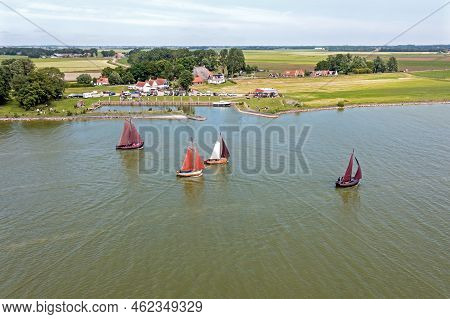 Aerial From Traditional Dutch Wooden Boats At The Ijsselmeer Near The Harbor From Laaxum In Frieslan