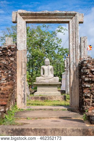 Thuparama Buddha Statue And The Temple Ruins. World Heritage Site In The Sacred City Of Anuradhapura