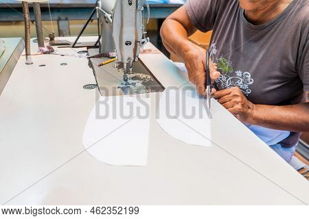 Unrecognizable Latin Woman Cutting Pieces Of A Guayabera Shirt