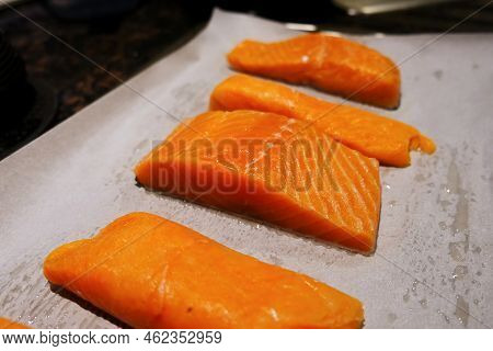 Raw Salmon Fresh Fish Fillet Steak Pieces With Salt And Pepper On The Baking Paper Sheet Ready To Ba