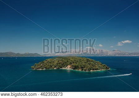 Popular Tourist Destination. Boat Sailing Near An Island Surrounded By Water. Nydri Village. Greece.