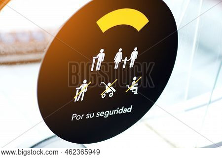 Warning Signs On An Escalator At The Shopping Mall In Spain, Safety Concept. Sign Of Passage With A 