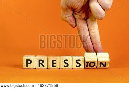 Pression To Free Press Symbol. Businessman Turns Wooden Cubes, Changes The Word Pression To Press. B