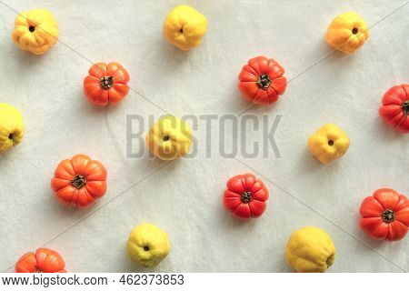 Colorful Autumn Pattern With Yellow Quince And Orange Pumpkins On Off White Cotton Textile Tabletop.