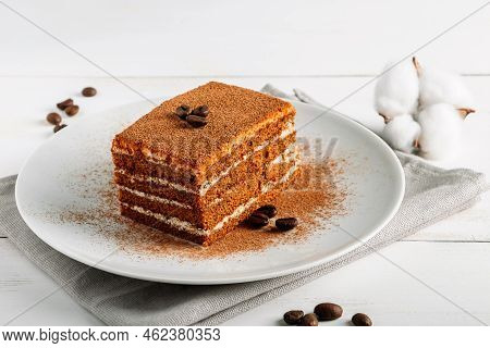 Traditional Italian Dessert Tiramisu On Light Background. Tiramisu Cake Decorated With Coffee Beans.