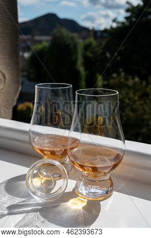 Two Glasses Of Single Malt Scotch Whisky Served On Old Window Sill In Scottisch House With View On O