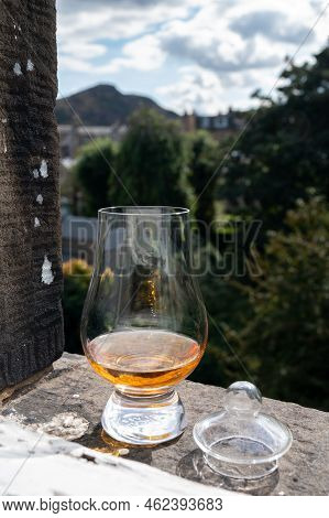 Glass Of Single Malt Scotch Whisky Served On Old Window Sill In Scottisch House With View On Old Par
