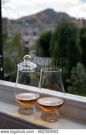 Two Glasses Of Single Malt Scotch Whisky Served On Old Window Sill In Scottisch House With View On O