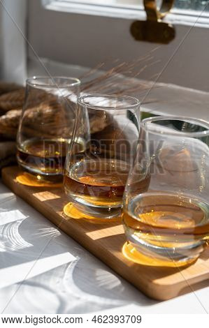 Flight Of Single Malt Scotch Whisky Served On Old Wooden Window Sill In Scottisch House In Edinburgh