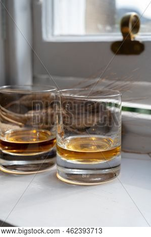 Two Glasses Of Single Malt Scotch Whisky Served On Old Wooden Window Sill In Scottisch House In Edin