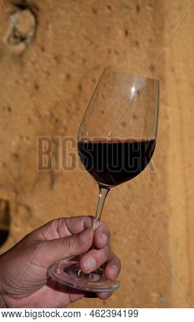 Tasting Of Red Wine By Old Wine Maker In Pierres Dorées Region With Yellow Stone Houses On South Of