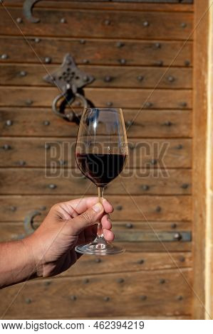 Tasting Of Red Wine By Old Wine Maker In Pierres Dorées Region With Yellow Stone Houses On South Of