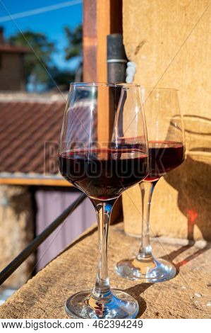 Tasting Of Red Wine By Old Wine Maker In Pierres Dorées Region With Yellow Stone Houses On South Of