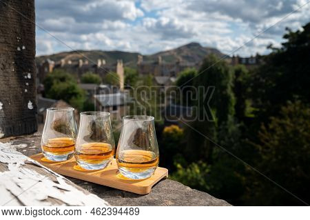 Flight Of Single Malt Scotch Whisky Served On Old Window Sill In Scottisch House With View On Old Pa