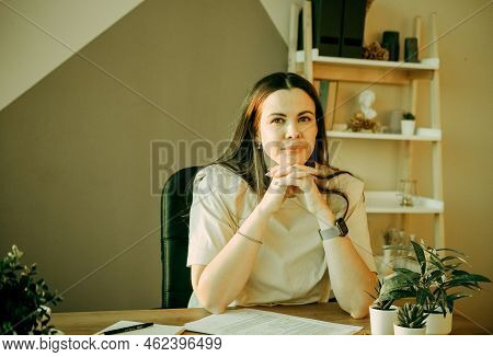 Woman On Remote Work Or Online Education, Using Tablet Computer, Papers And Notes, Indoors At Office