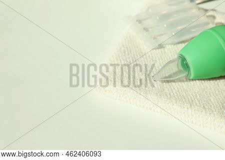 Single Dose Ampoules Of Sterile Isotonic Sea Water Solution, Towel And Nasal Aspirator On White Tabl