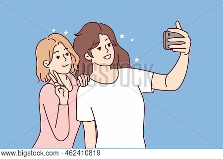 Smiling Girls Making Selfie On Smartphone Together. Happy Women Have Fun Take Self-portrait Picture 