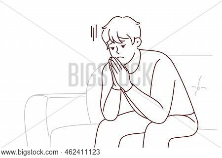 Unhappy Young Man Sit On Sofa Thinking Worrying About Life Problem. Upset Stressed Male On Couch At 