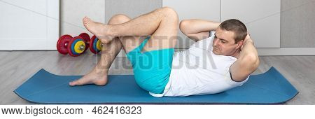 A Strong, Healthy Man With Muscles, Training At Home In The Plank Position. Fitness At Home. Banner