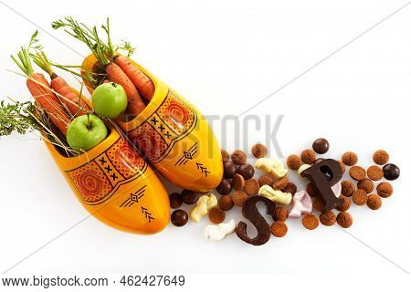 Saint Nicholas - Sinterklaas Day With Shoe, Carrot And Traditional Sweets On White Background