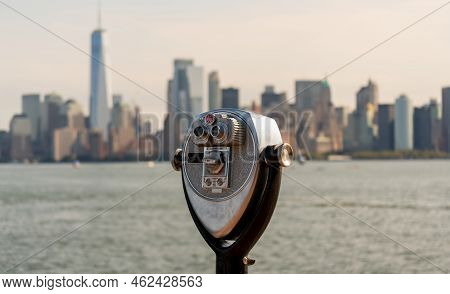 Tourist Binoculars On Liberty Island Overlooking Downtown Manhattan, New York, Usa.