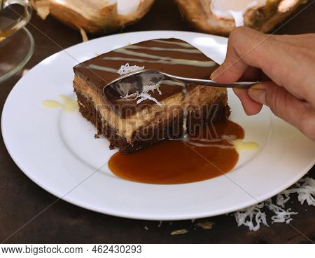 Hand Taking Spoon A Piece Of Coconut Cake